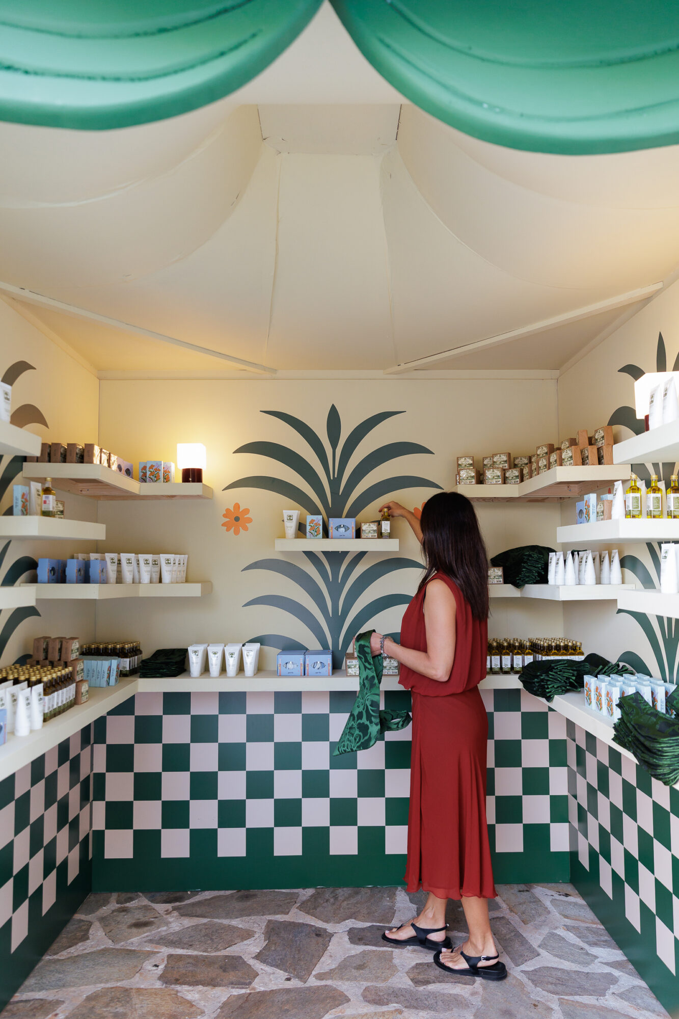 Cabana filled with Greek and personalized wedding gifts with a guest selecting what they want
