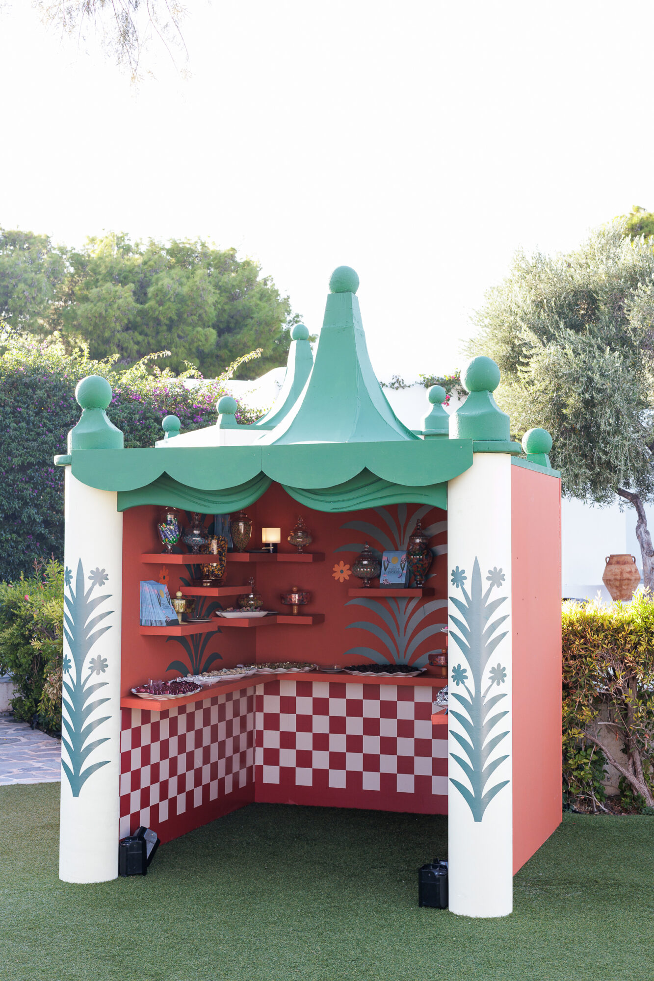 Red cabana filled with Greek sweets and candy for wedding guests to take