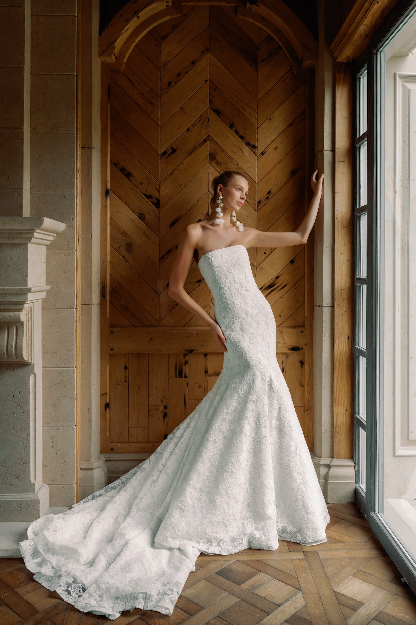 Love Story wedding dress embroidered lace neckline and a dramatic fit-and-flare skirt and long earrings 