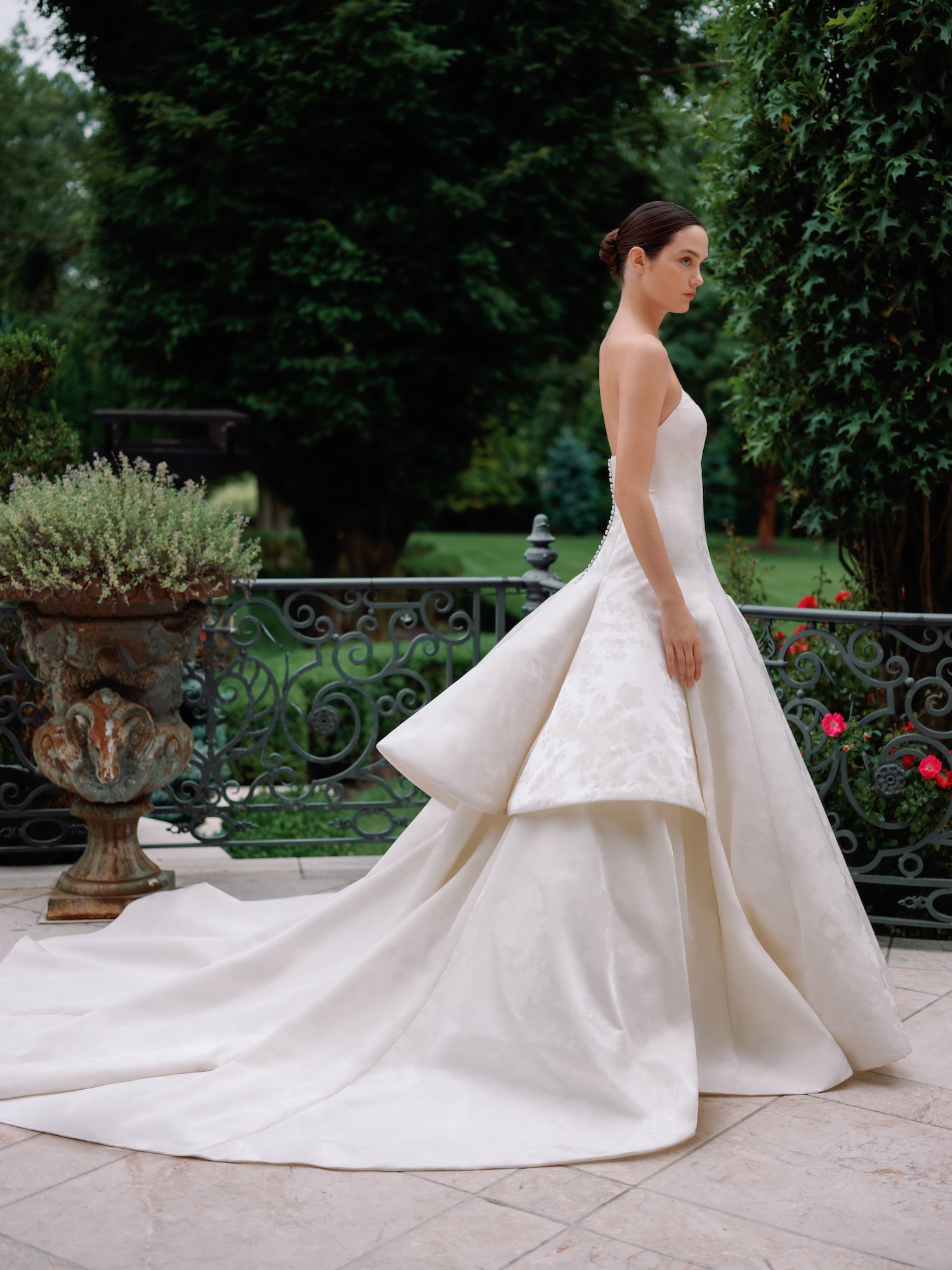 Bride walking down a luxury venue with her floral printed radzimir wedding ballgown and dramatic train  