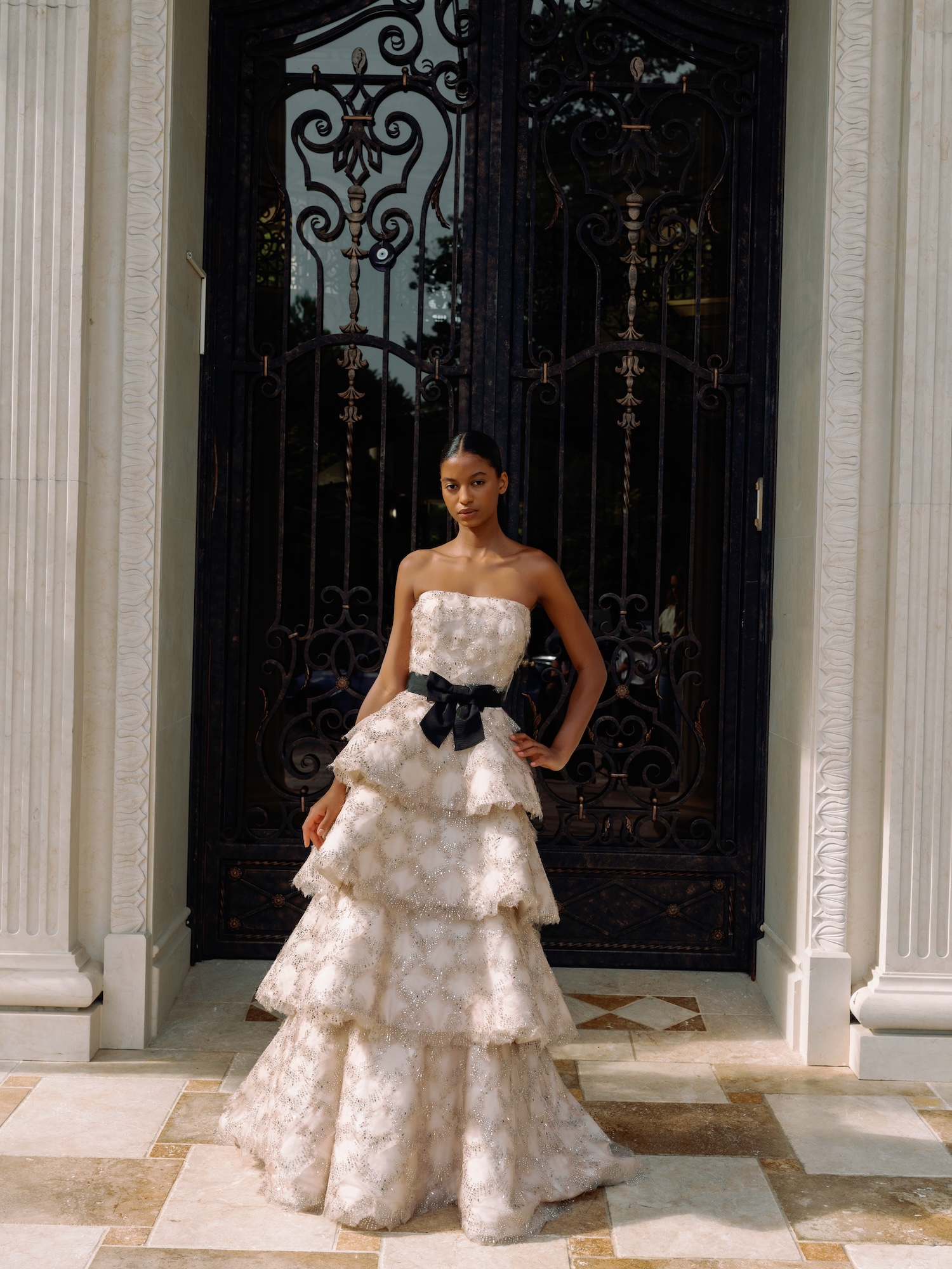 Mademoiselle weddind dress with hand beaded organza straight neckline natural waist with tiered modified aline skirt in Ivory-nude color and black belt with bow