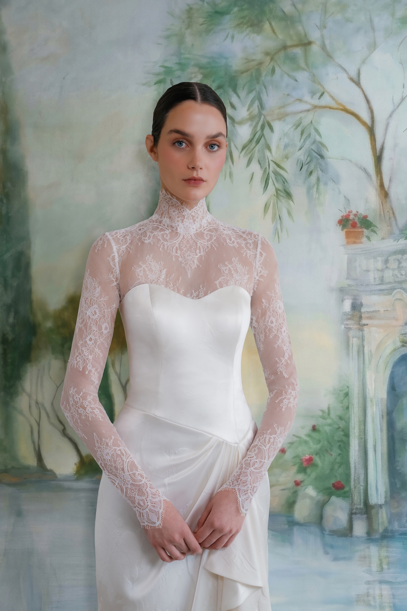 Bride in chantilly lace dress with high neck fitted long sleeve with scallop trim at neckline and wrists.