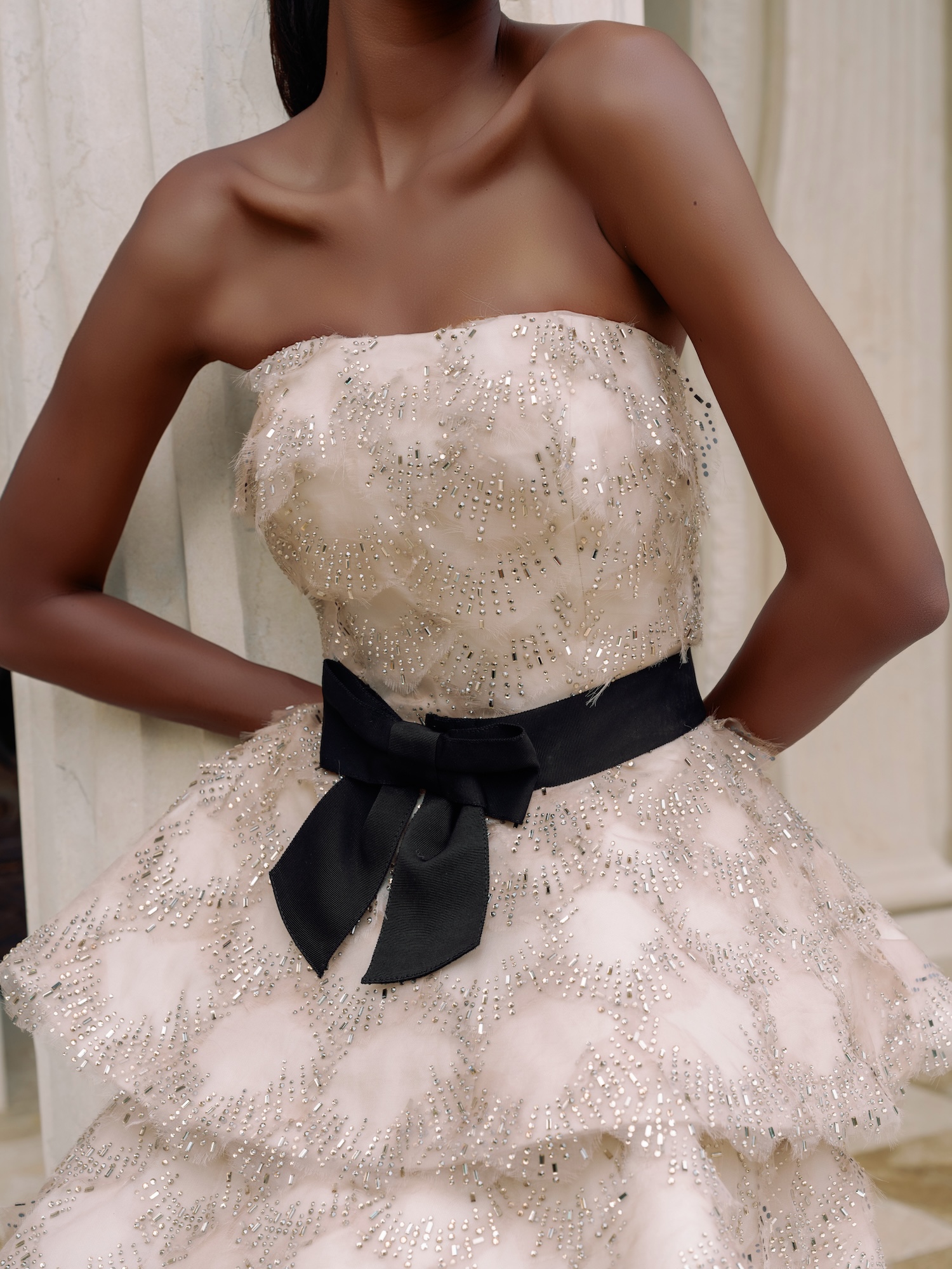 Details of hand beaded organza straight across neckline natural waist with black bow belt