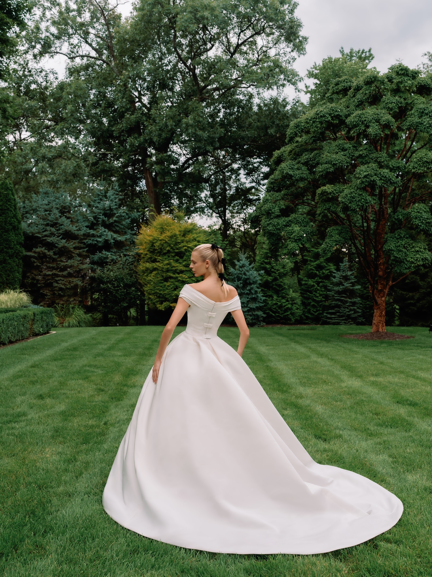 Backside of the silk faille The Heiress wedding ballgown dress with bows and draping throughout the bodice.