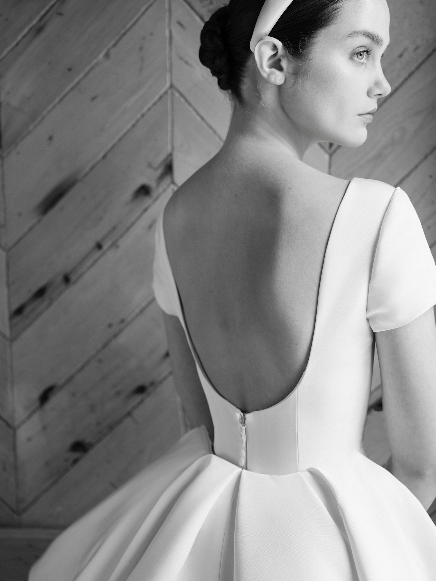 Close-up of an open-back timeless and elegant wedding dress. 