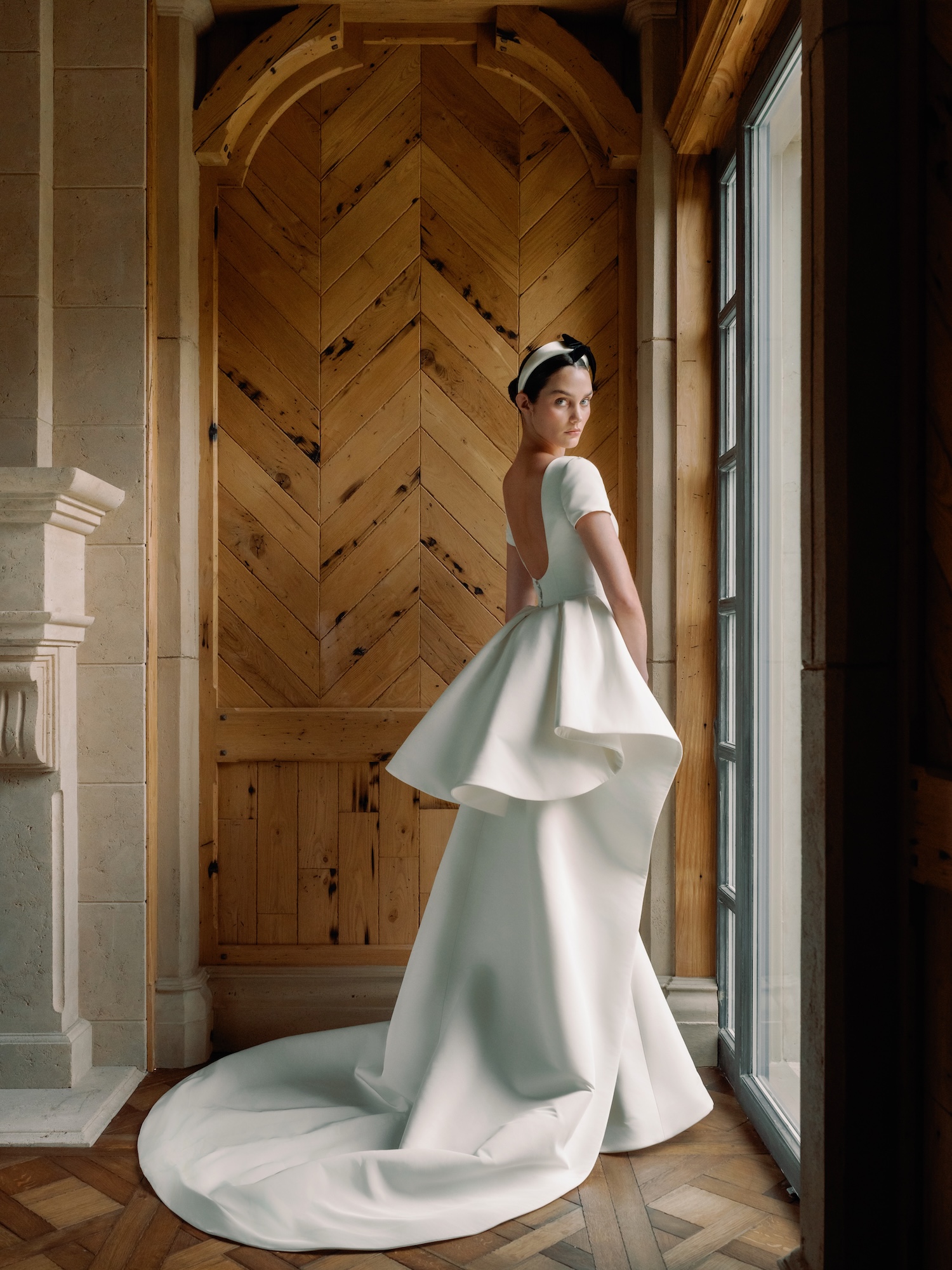 White Glove wedding dress with silk faille, low scoop back neckline with slim flare gown and dramatic ruffle overskirt.